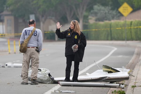 Investigators work at the site of a plane crash Friday, May 23, 2025, in San Diego. (AP Photo/Gregory Bull)