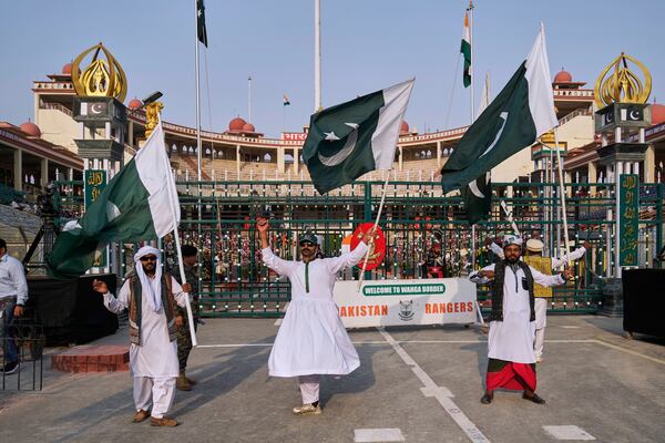Pakistan's folk dancers perform with national flag during a daily closing ceremony at the Wagah, a joint post on the Pakistan and India border, near Lahore, Pakistan, Saturday, May 3, 2025. (AP Photo/K.M. Chaudary)