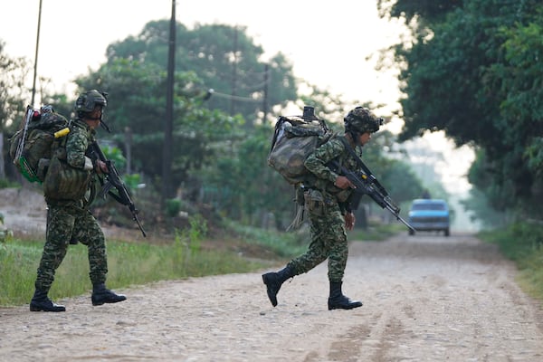 Soldiers patrol in Tibu, Colombia, Tuesday, Jan. 21, 2025, following guerrilla attacks that have killed dozens of people and forced thousands to flee their homes in the Catatumbo region. (AP Photo/Fernando Vergara)