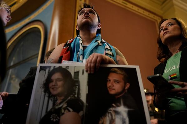 Laker Fuller and other protesters fill the Iowa state Capitol to denounce a bill that would strip the state civil rights code of protections based on gender identity, Thursday, Feb. 27, 2025, in Des Moines, Iowa. (AP Photo/Charlie Neibergall)