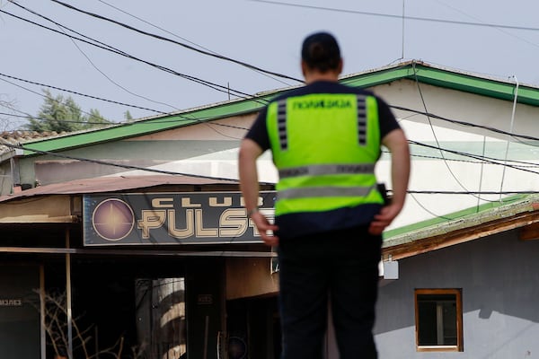 A police officer inspects a nightclub in the town of Kocani, North Macedonia, Sunday, March 16, 2025, following a massive fire in the nightclub early Sunday. (AP Photo/Visar Kryeziu)