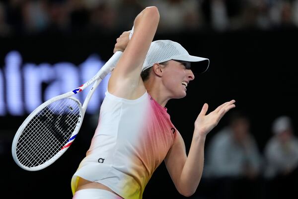 Iga Swiatek of Poland plays a forehand return to Madison Keys of the U.S. during their semifinal match at the Australian Open tennis championship in Melbourne, Australia, Thursday, Jan. 23, 2025. (AP Photo/Asanka Brendon Ratnayake)