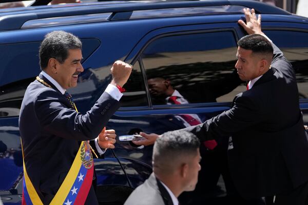 Venezuela's President Nicolas Maduro gestures to government supporters before entering a vehicle after his inauguration for a third term in Caracas, Venezuela, Friday, Jan. 10, 2025. (AP Photo/Matias Delacroix)