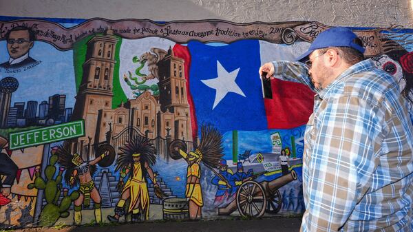 Rolando Salas, originally for Mexico, photographs a mural made by artist Jesus Alba to commemorate the 1862 battle of Puebla between the French and Mexican army during a Cinco De Mayo celebration in the Oak Cliff section of Dallas, May 3, 2025. Salas called the May 5th holiday, "A celebration of us." (AP Photo/LM Otero)