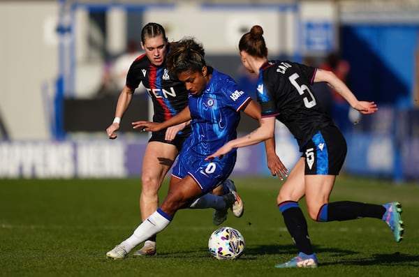 Chelsea's Catarina Macario in action with Crystal Palace's Molly-Mae Sharpe, left, and My Cato during the Women's FA Cup quarterfinal soccer match between Chelsea and Crystal Palace at Kingsmeadow, London, Sunday March 9, 2025. (Jordan Pettitt/PA via AP)