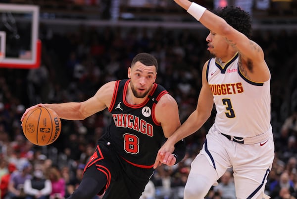 Chicago Bulls guard Zach LaVine (8) drives to the basket against Denver Nuggets guard Julian Strawther (3) during the first half of an NBA basketball game Monday, Jan. 27, 2025, in Chicago. (AP Photo/Melissa Tamez)