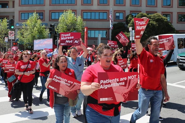 In this photo provided by National Nurses United, nurses hold a rally in San Francisco on April 22, 2024, to highlight safety concerns about using artificial intelligence in health care. (National Nurses United via AP)