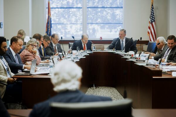 Members of the Mississippi Joint Legislative Budget Committee listen to Mississippi Department of Corrections Commissioner Burl Cain, bottom center, at the Woolfolk state office building Sept. 26, 2024, in Jackson, Miss. (AP Photo/Justin Hardiman)