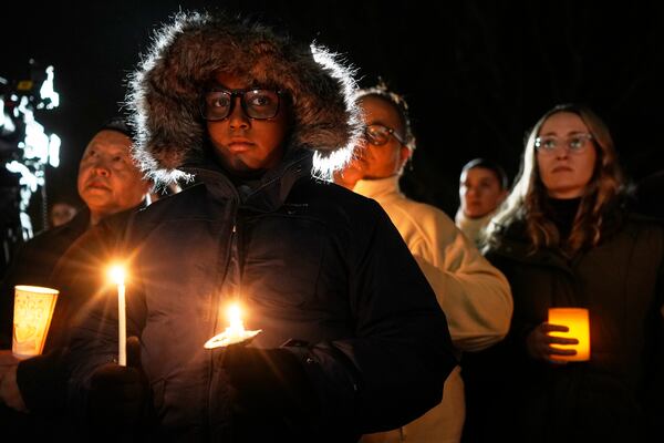 Supporters hold candles during a candlelight vigil Tuesday, Dec. 17, 2024, outside the Wisconsin Capitol in Madison, Wis., following a shooting at the Abundant Life Christian School on Monday, Dec. 16. (AP Photo/Morry Gash)