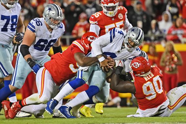 FILE - Kansas City Chiefs defensive tackle Jarran Reed (90) and defensive end Chris Jones (95) sack Dallas Cowboys quarterback Dak Prescott (4) during an NFL football game, Sunday, Nov. 21, 2021, in Kansas City, Mo. (AP Photo/Peter Aiken, File)