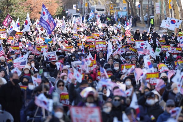 Supporters of impeached South Korean President Yoon Suk Yeol hold signs during a rally to oppose his impeachment near the Constitutional Court in Seoul, South Korea, Thursday, Feb. 13, 2025. The letters read "Nullity Impeachment" (AP Photo/Lee Jin-man)