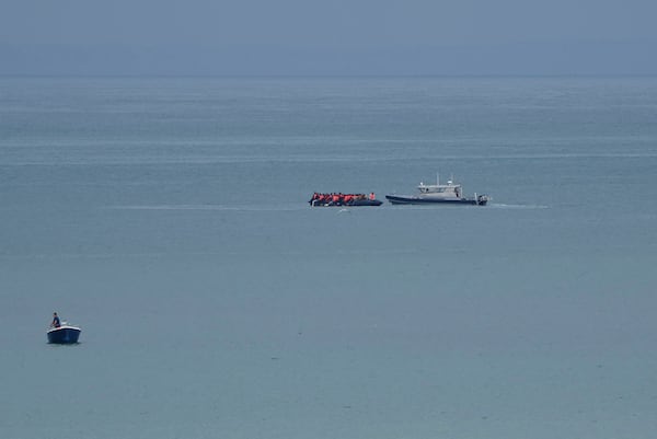 FILE- A boat thought to be with migrants is escorted by a vessel from the French Gendarmerie Nationale off the Wimereux beach, France, on Sept. 4, 2024. (AP Photo/Nicolas Garriga, File)