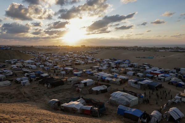 The sun sets above the Mawasi tent camp for displaced Palestinians in Khan Younis, central Gaza Strip, Saturday Jan. 18, 2025.(AP Photo/(AP Photo/Jehad Alshrafi)