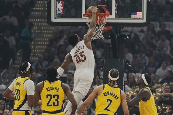 Cleveland Cavaliers guard Donovan Mitchell (45) dunks in front of Indiana Pacers center Myles Turner (33), forward Aaron Nesmith (23), guard Andrew Nembhard (2) and forward Pascal Siakam, right, in the first half during Game 2 in the Eastern Conference semifinals of the NBA basketball playoffs Tuesday, May 6, 2025, in Cleveland. (AP Photo/Sue Ogrocki)
