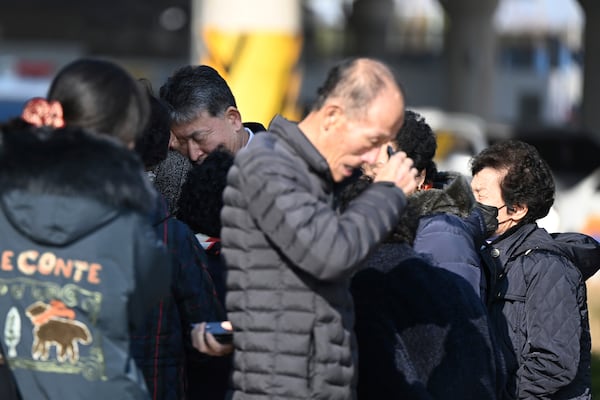 Family members of the passengers on a plane which burst into flames, weep at the Muan International Airport in Muan, South Korea, Sunday, Dec. 29, 2024. (Park Ki-woong/Newsis via AP)