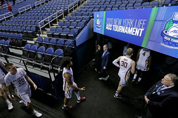 FILE - Florida State players leave the court after the NCAA college basketball games at the Atlantic Coast Conference tournament were canceled due to coronavirus concerns, Thursday, March 12, 2020, in Greensboro, N.C. (AP Photo/Gerry Broome, File)