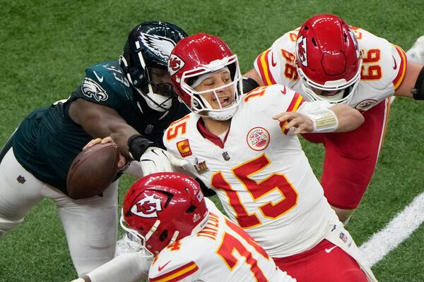 Philadelphia Eagles defensive tackle Milton Williams (93) strips the ball from Kansas City Chiefs quarterback Patrick Mahomes (15) during the second half of the NFL Super Bowl 59 football game, Sunday, Feb. 9, 2025, in New Orleans. (AP Photo/Charlie Riedel)