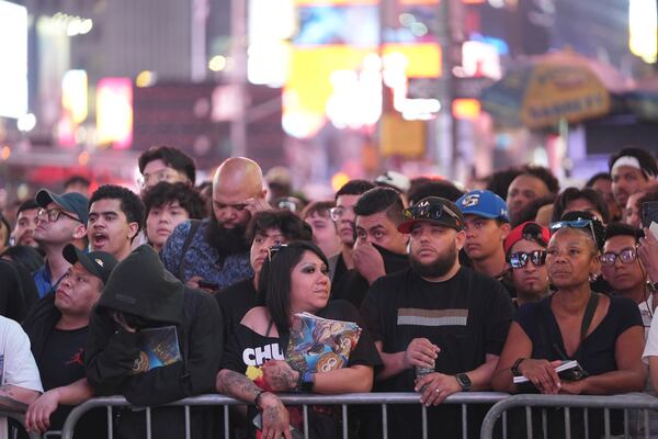 People gather in Times Square to watch a boxing match Friday, May 2, 2025, in New York. (AP Photo/Frank Franklin II)