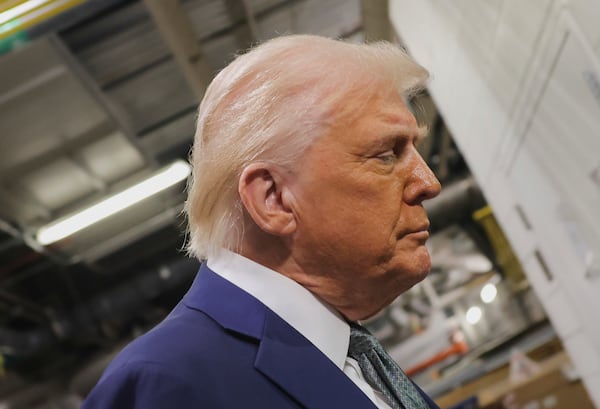 President Donald Trump talks with reporters as he visits the John F. Kennedy Center for the Performing Arts in Washington, Monday, March 17, 2025. (Pool via AP)