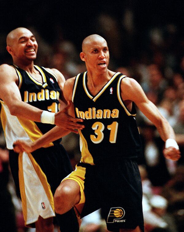FILE - Indiana Pacers guards Reggie Miller (31) and Mark Jackson taunt New York film director and avid Knicks fan Spike Lee, after Miller scored eight points in the last quarter of the game against the Knicks, at New York's Madison Square Garden, May 7, 1995. (AP Photo/Bill Kostroun, File)