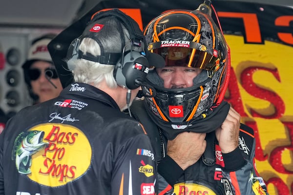 Martin Truex Jr., right, talks to a crew member during a practice for the NASCAR Daytona 500 auto race Wednesday, Feb. 12, 2025, at Daytona International Speedway in Daytona Beach, Fla. (AP Photo/Chris O'Meara)