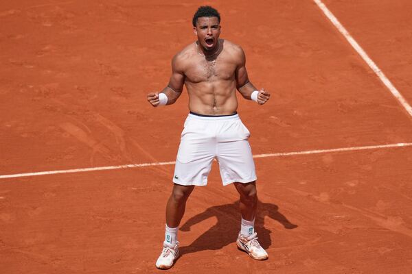 France's Arthur Fils celebrates beating Spain's Jaume Munar after their second round match of the French Tennis Open, at the Roland-Garros stadium, in Paris, Thursday, May 29, 2025. (AP Photo/Christophe Ena)