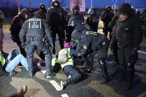 Police clear a sit-in blockade at a demonstration against the AfD's national party conference Saturday, Jan. 11, 2025, in Saxony, Riesa, Germany. (Jan Woitas/dpa via AP)