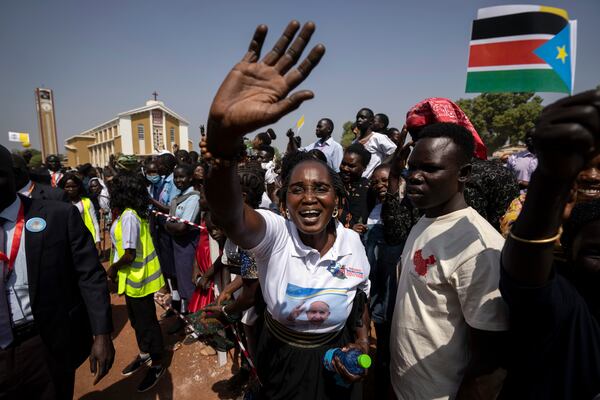 FILE - People in the crowd cheer and wave as Pope Francis is wheeled past after addressing clergy at the St. Theresa Cathedral in Juba, South Sudan, Saturday, Feb. 4, 2023. (AP Photo/Ben Curtis, File)
