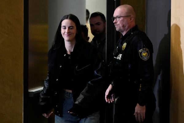 Former Iowa guard and current Indiana Fever WNBA player Caitlin Clark arrives at a news conference before an NCAA college basketball game between Iowa and USC, Sunday, Feb. 2, 2025, in Iowa City, Iowa. (AP Photo/Charlie Neibergall)