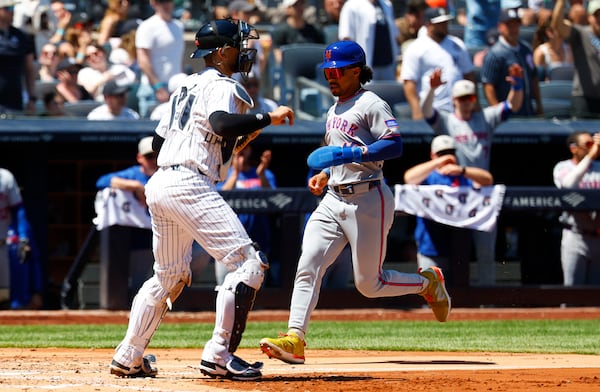 New York Mets' Francisco Lindor (12) scores a run against the New York Yankees during the fourth inning of a baseball game, Saturday, May 17, 2025, in New York. (AP Photo/Noah K. Murray)