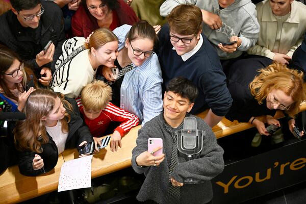 JJ, center, from Austria arrives at the airport in Vienna, Austria, Sunday, May 18, 2025, after winning the Grand Final of the 69th Eurovision Song Contest, in Basel yesterday. (AP Photo/Denes Erdos)