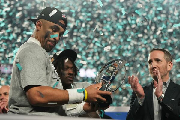 Philadelphia Eagles quarterback Jalen Hurts holds the championship trophy after the Eagles won the NFC Championship NFL football game against the Washington Commanders, Sunday, Jan. 26, 2025, in Philadelphia. (AP Photo/Matt Slocum)