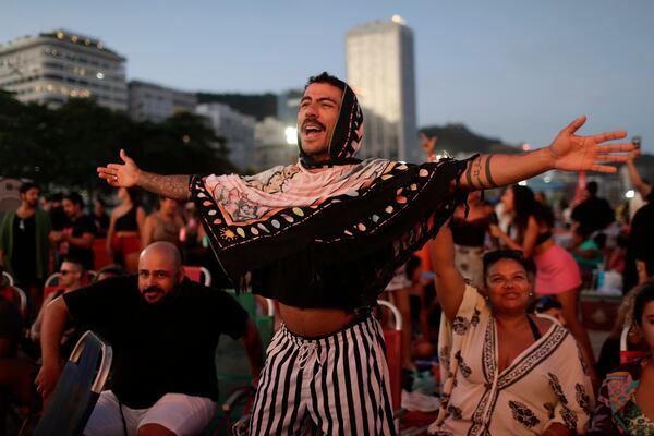 A fan cheers while waiting for the start of Lady Gaga's free concert on Copacabana beach in Rio de Janeiro, Saturday, May 3, 2025. (AP Photo/Bruna Prado)