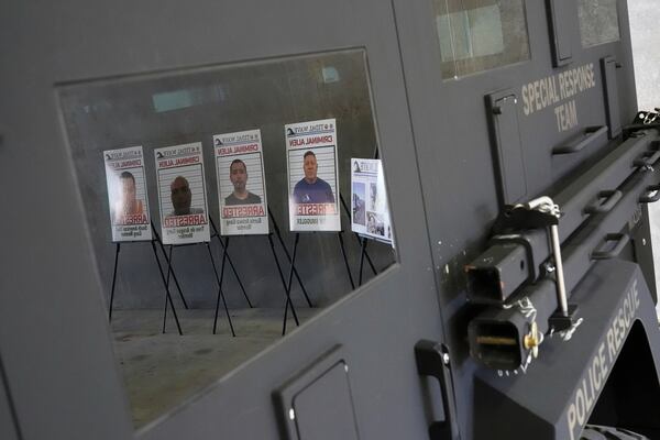 Posters of alleged criminals who officials said were arrested in a recent immigration enforcement operation are reflected in a Department of Homeland Security vehicle during a press conference with Gov. Ron DeSantis at the South Florida office of U.S. Immigration and Customs Enforcement and Enforcement and Removal Operations, Thursday, May 1, 2025, in Miramar, Fla. (AP Photo/Rebecca Blackwell)