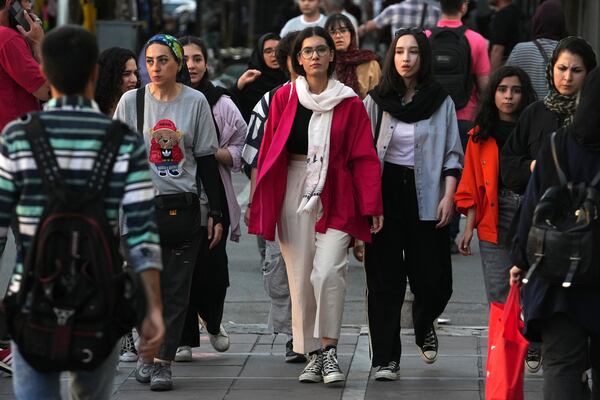 FILE Iranian women, some without wearing their mandatory Islamic headscarves, walk in downtown Tehran, Iran, Saturday, Sept. 9, 2023. (AP Photo/Vahid Salemi, File)