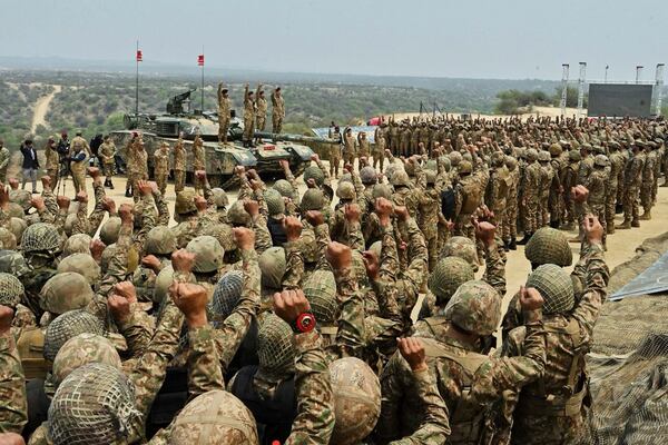 In this photo released by the Inter Services Public Relations, Pakistan's Army Chief Asim Munir, second left standing on tank, chant 'long live Pakistan' slogans with soldiers during his visit to witness military exercises, in Tilla Field Firing Range in the Jhelum district, Pakistan, Thursday, May 1, 2025. (Inter Services Public Relations via AP)