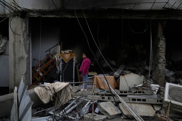 Residents inspect the location of the Israeli airstrike that killed six Palestinians on Wednesday, in the West Bank refugee camp of Jenin Thursday, Jan. 16, 2025. (AP Photo/Nasser Nasser)