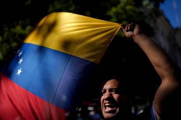 An opponent of Venezuelan President Nicolas Maduro protests the day before his inauguration for a third term, at Plaza de Mayo in Buenos Aires, Argentina, Thursday, Jan. 9, 2025. (AP Photo/Natacha Pisarenko)