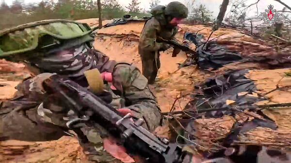 In this photo taken from video distributed by Russian Defense Ministry Press Service on Wednesday, May 21, 2025, Russian servicemen attend a combat training for assault units in an undisclosed location in Ukraine. (Russian Defense Ministry Press Service via AP)