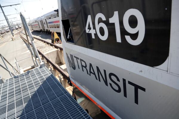 FILE - A train is seen on a maintenance track at New Jersey Transit's Meadows Maintenance Complex, Tuesday, May 1, 2018, in Kearny, N.J. (AP Photo/Julio Cortez, File)