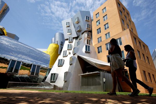 FILE - People walk past the Ray and Maria Stata Center on the campus of the Massachusetts Institute of Technology, in Cambridge, Mass., on July 16, 2019. (AP Photo/Steven Senne, File)