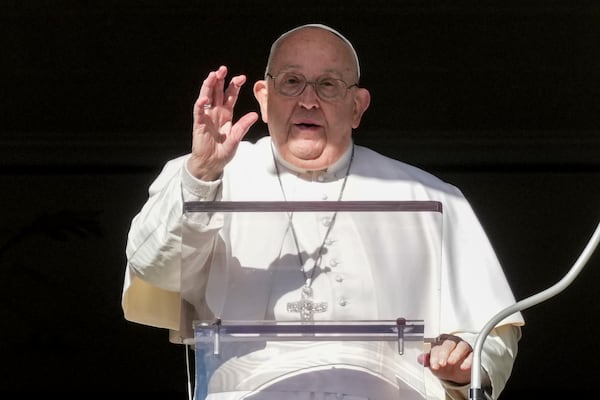 Pope Francis delivers his blessing as he recites the Angelus noon prayer from the window of his studio overlooking St.Peter's Square, at the Vatican, Thursday, Dec. 26, 2024. (AP Photo/Andrew Medichini)