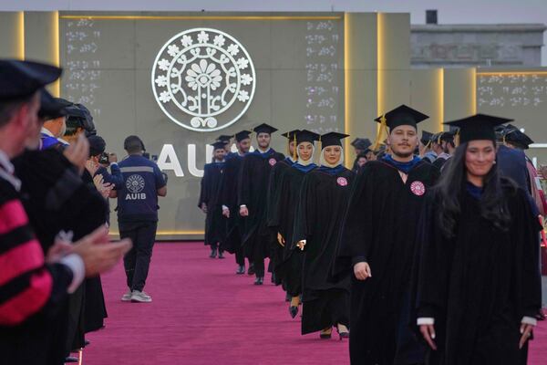 The American University of Iraq - Baghdad students stand together during the first graduation for the school in Baghdad, Iraq, Saturday, May 24, 2025. (AP Photo/Hadi Mizban)