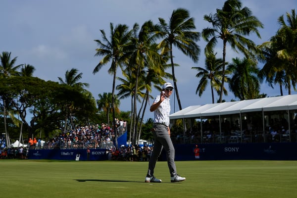 Nico Echavarria, of Columbia, reacts after making a shot on the 18th green during the final round of the Sony Open golf event, Sunday, Jan. 12, 2025, at Waialae Country Club in Honolulu. (AP Photo/Matt York)