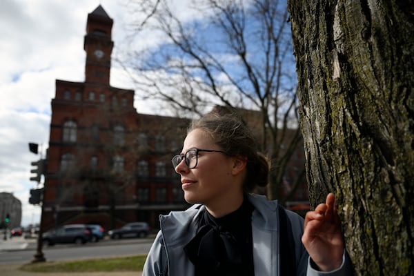 Sydney Smith, who lost her job due to DOGE cuts, stands in front of the Sydney Yates building that houses the Forest Service on Thursday, March. 6, 2025, in Washington. (AP Photo/John McDonnell)