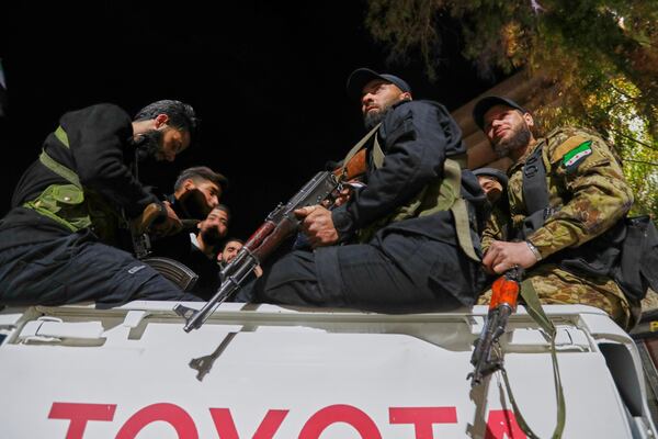 Syria's security forces stand on their vehicle, after reaching a deal with Druze gunmen to deploy around Jaramana, a Damascus suburb that saw fighting earlier this week, in Damascus, Syria, early Friday, May 2, 2025. (AP Photo/Omar Sanadiki)