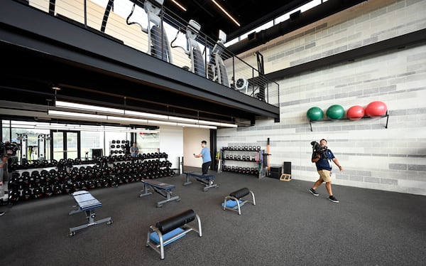 Members of the media look over the New York Yankees weight room during a tour of the upgraded team spring training facilities Thursday, Feb 13, 2025 at George M. Steinbrenner Field, in Tampa, Fla. (AP Photo/Steve Nesius)