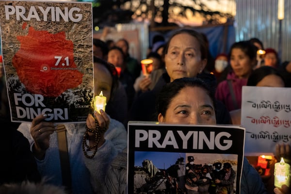 Exiled Tibetans participate in a candlelit vigil in Dharamshala, India, Wednesday, Jan. 8, 2025, in solidarity with the victims of an earthquake that hit a high-altitude Tibet region in western China on Tuesday. (AP Photo/Ashwini Bhatia)