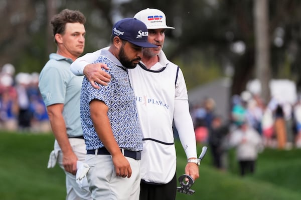 J.J. Spaun, center, reacts after a putt on the 18th green during the final round of The Players Championship golf tournament Sunday, March 16, 2025, in Ponte Vedra Beach, Fla. (AP Photo/Julia Demaree Nikhinson)