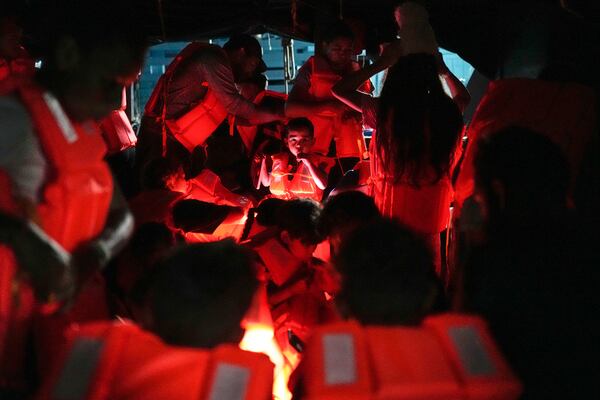 Migrants board a boat at the Caribbean coastal village of Miramar, Panama, bound for the Colombian border, Thursday, Feb. 27, 2025, as migrants return from southern Mexico after abandoning hopes of reaching the U.S. in a reverse flow triggered by the Trump administration's immigration crackdown. (AP Photo/Matias Delacroix)